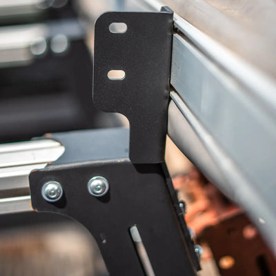 Bed rack awning mount bracket close up showing steel construction and slotted mounting holes