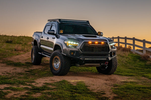 Lifted 2016-2023 Toyota Tacoma with Attica Apex Series headlights and DRL on at dusk