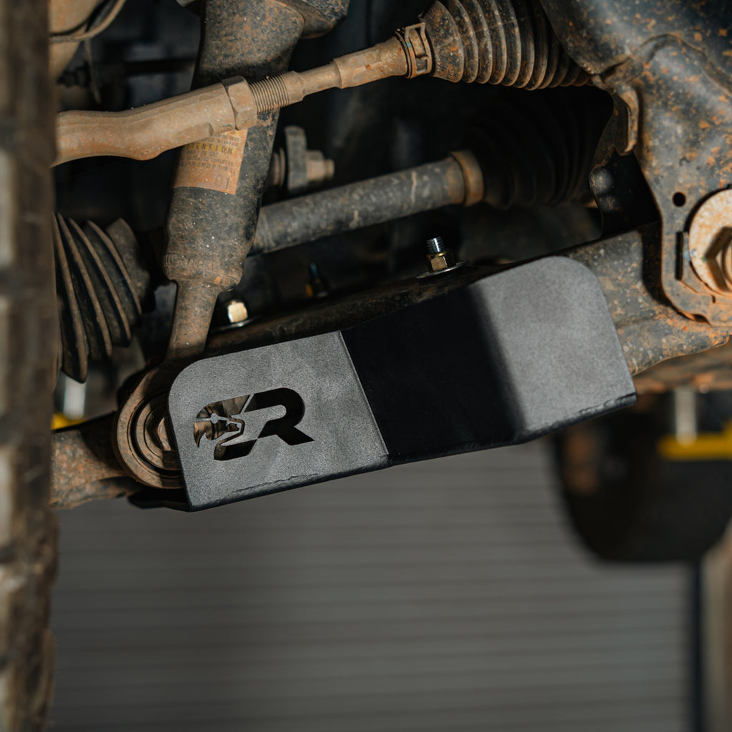 Close-up of a Cali Raised LED lower control arm skid plate on a sixth-gen Toyota 4Runner