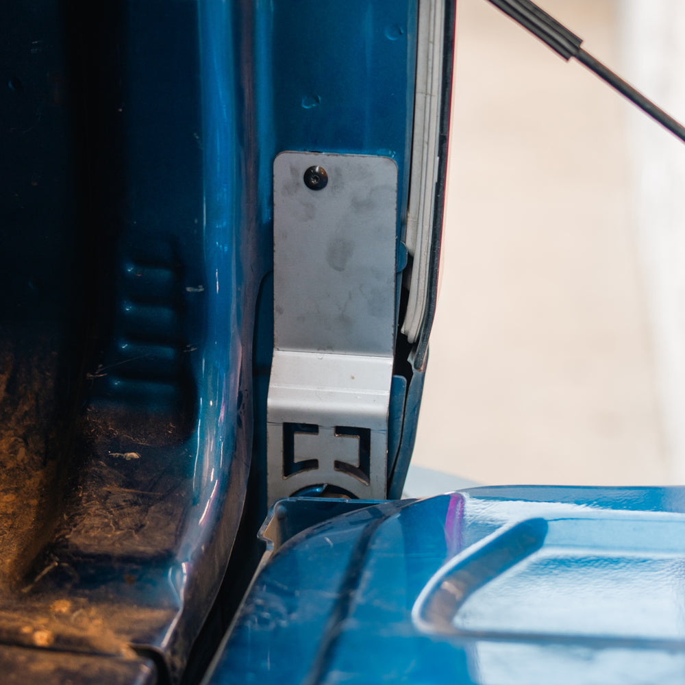 Cali Raised LED tailgate theft protector installed on the passenger-side rear bed-end jamb of a 2015-2022 Chevy Colorado, held by the truck's own factory bolt. Current protector shown.