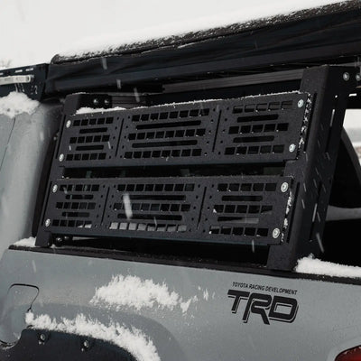 Close-up of Cali Raised LED Overland Bed Rack on TRD Tacoma in snowy conditions