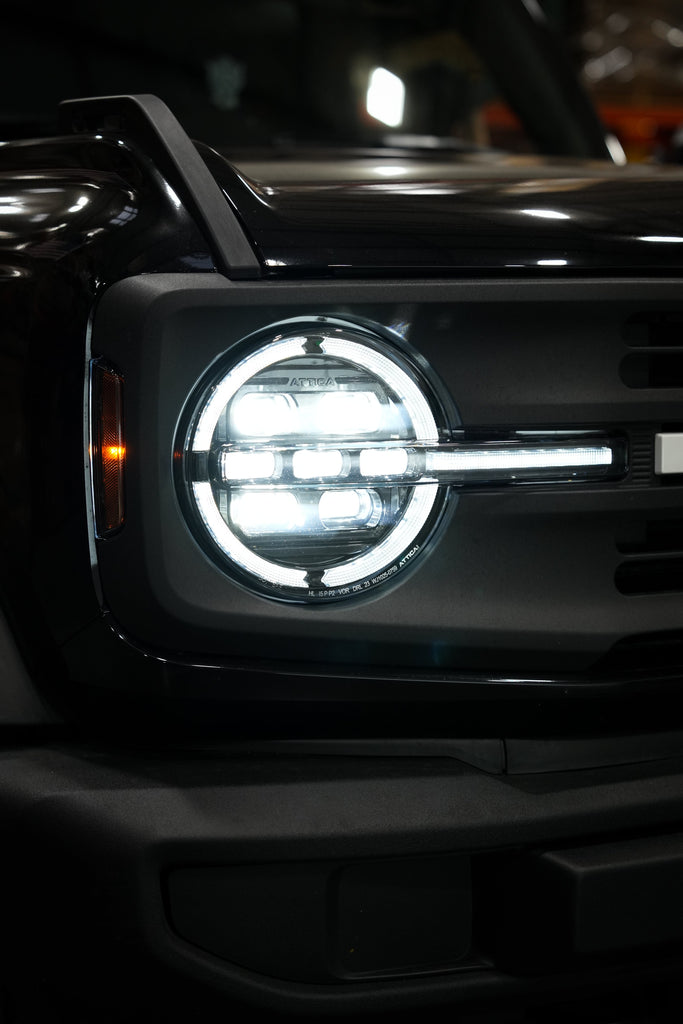 Attica Apex Series headlight installed on a Ford Bronco at night with white DRL
