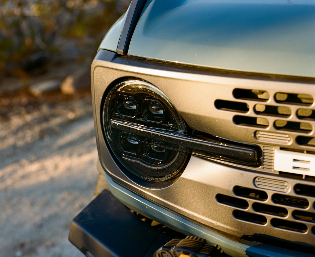Close-up of an Attica Sol Series headlight on a Ford Bronco grille